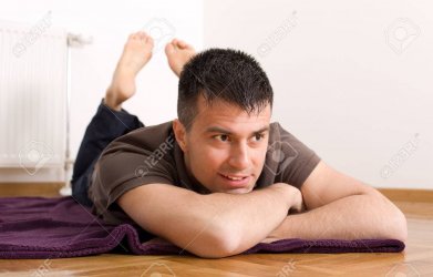 39031032-close-up-of-attractive-man-lying-on-the-floor-on-stomach-with-legs-up.jpg